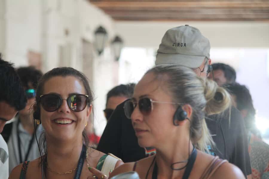 Shared Old Cartagena & Getsemani Tour with Wireless System - Meeting at Santo Domingo Square with red umbrellas and a receiver